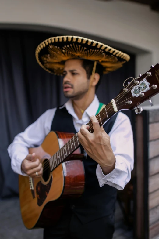 a man in a sombren playing a guitar, an album cover, inspired by Germán Londoño, pexels contest winner, wearing sombrero, an olive skinned, jordan lamarre - wan, profile pic