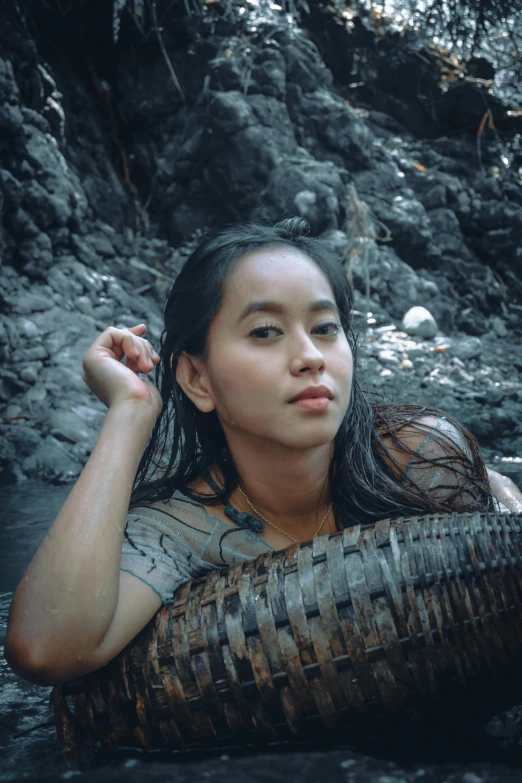 a woman floating in a body of water, an album cover, inspired by Fernando Amorsolo, pexels contest winner, sumatraism, portrait rugged girl, grey, gif, creek