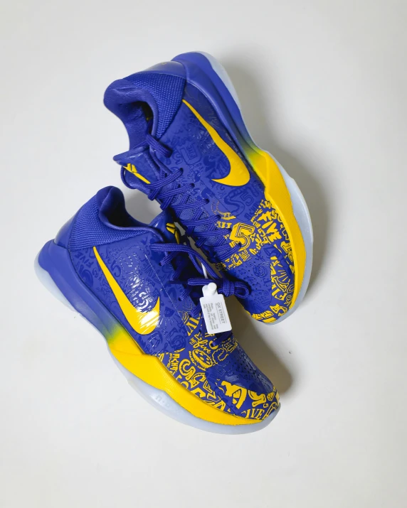 a pair of blue and yellow shoes on a white surface, by Kyle Lambert, dribble, kobe bryant, ebay listing thumbnail, 中 国 鬼 节, lunar themed attire