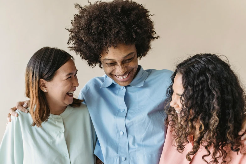 a group of three women standing next to each other, trending on pexels, happening, smiling warmly, avatar image, nursing, brown