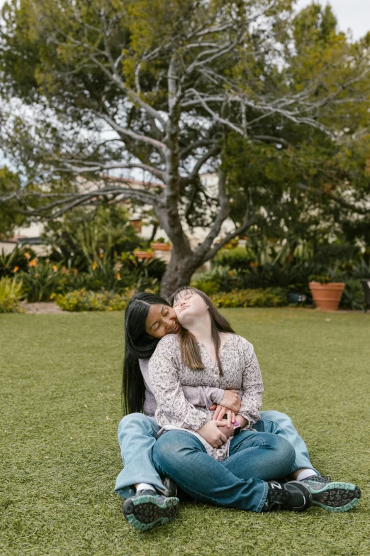 a couple of women sitting on top of a lush green field, audrey plaza, licking out, non-binary, in a square