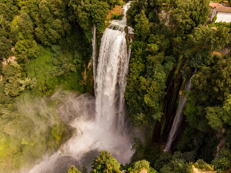 a waterfall in the middle of a lush green forest, pexels contest winner, hurufiyya, airborne view, madagascar, avatar image, towering high up over your view