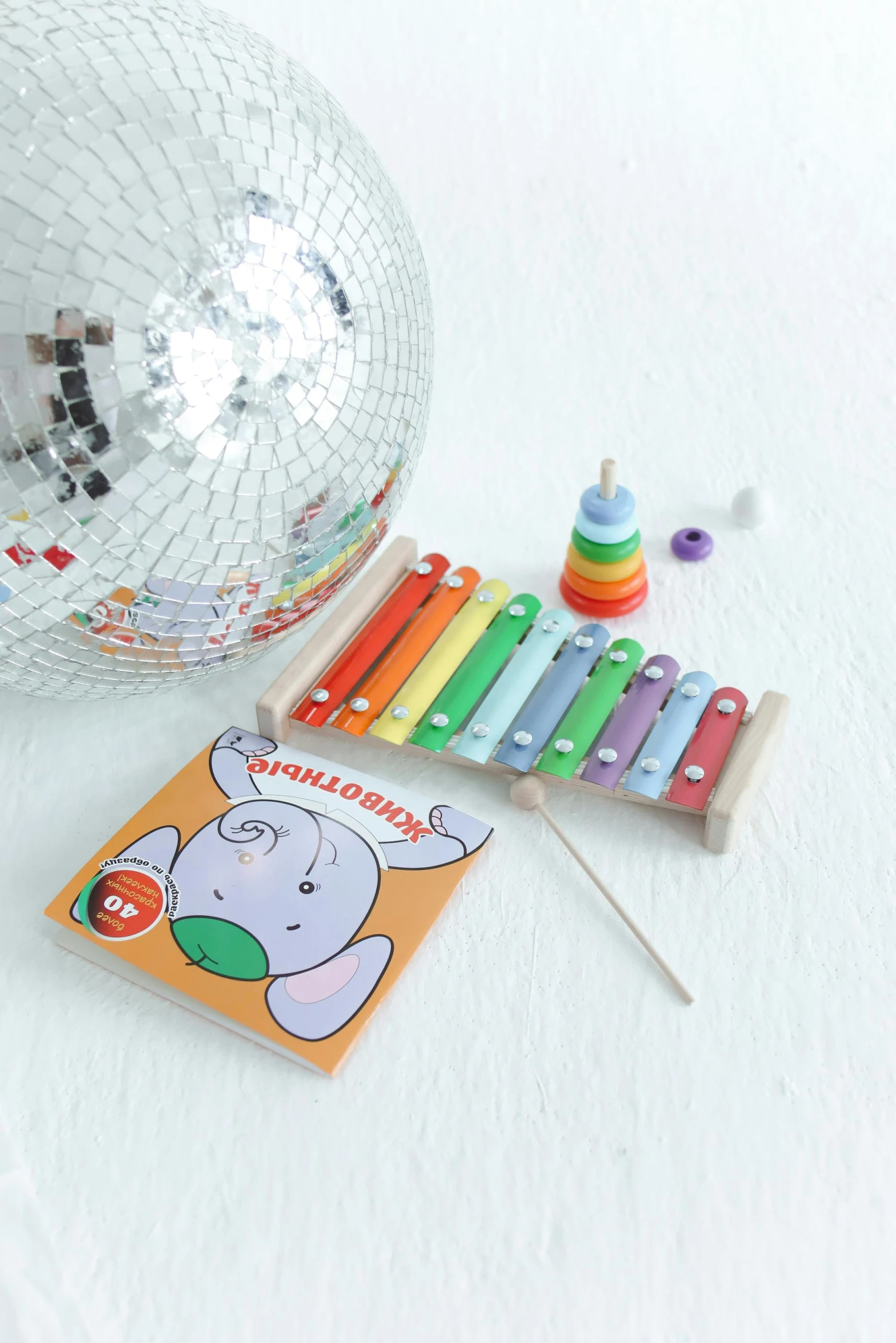 a disco ball sitting on top of a white table, an album cover, by Julia Pishtar, wooden art toys, xylophone, cute elephant, detailed product photo