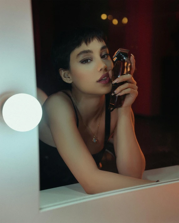 a woman taking a picture of herself in a mirror, inspired by Nan Goldin, trending on pexels, :: madison beer, carrying a bottle of perfume, kiko mizuhara, with high cheekbones