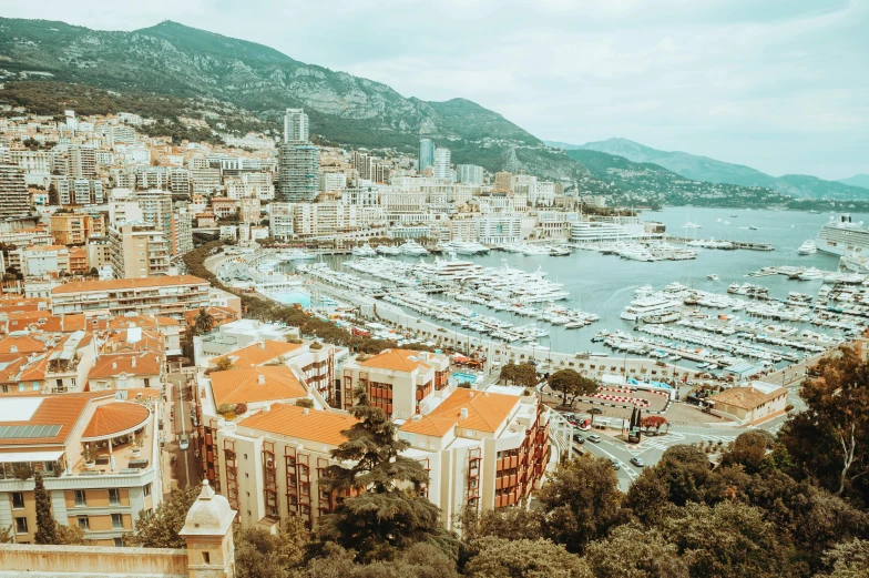 a view of a city from the top of a hill, a colorized photo, pexels contest winner, art nouveau, monaco, on a super yacht, brown, drone footage