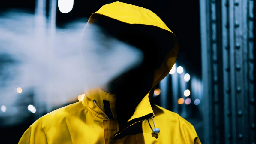 a person in a yellow jacket smoking a cigarette, inspired by Attila Meszlenyi, unsplash, eyes projected onto visor, hood and cape, storm outside, vapourwave