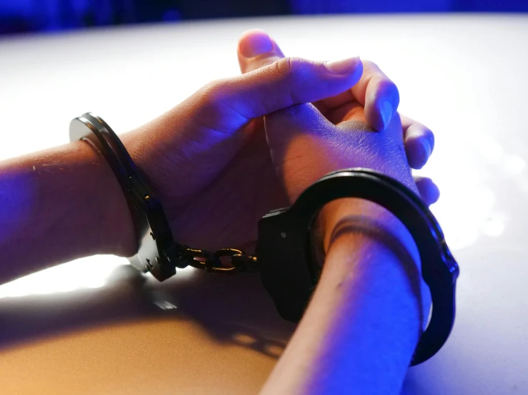 a close up of two people holding hands, private press, arrested, black light, background image, no cropping