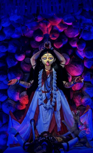 a close up of a statue of a woman, an album cover, bengal school of art, elaborate stage effects, red glowing eyes, blue colored traditional wear, 2022 photograph