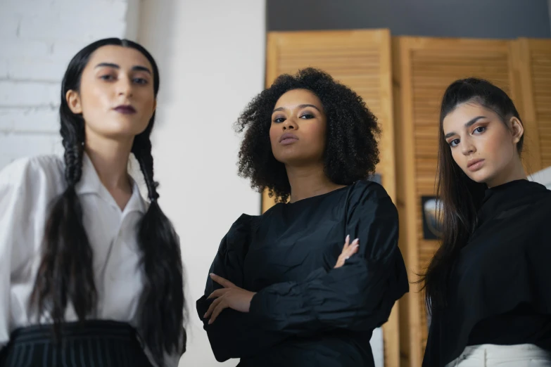 three women standing next to each other in a room, trending on pexels, renaissance, black, avatar image, proud serious expression, professional image