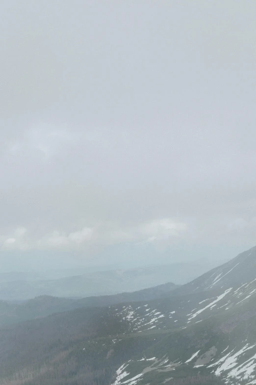 a man riding a snowboard down a snow covered slope, inspired by Andreas Gursky, overcast!!!, panoramic, july 2 0 1 1, high above treeline