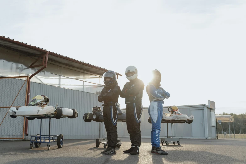 a group of people standing next to each other, race style, formulae, profile image, maintenance