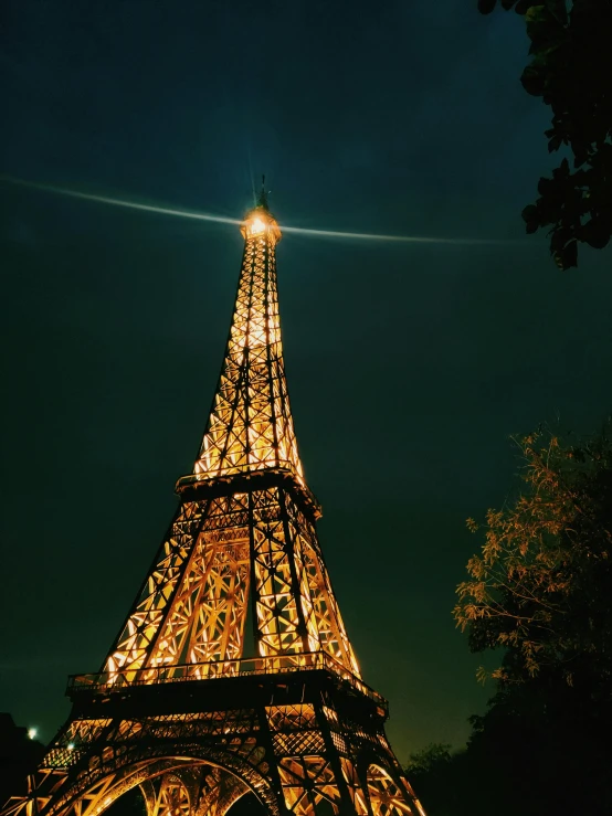 the eiffel tower is lit up at night, an album cover, pexels contest winner, medium format. soft light, outdoor photo, 1 4 9 3, tall