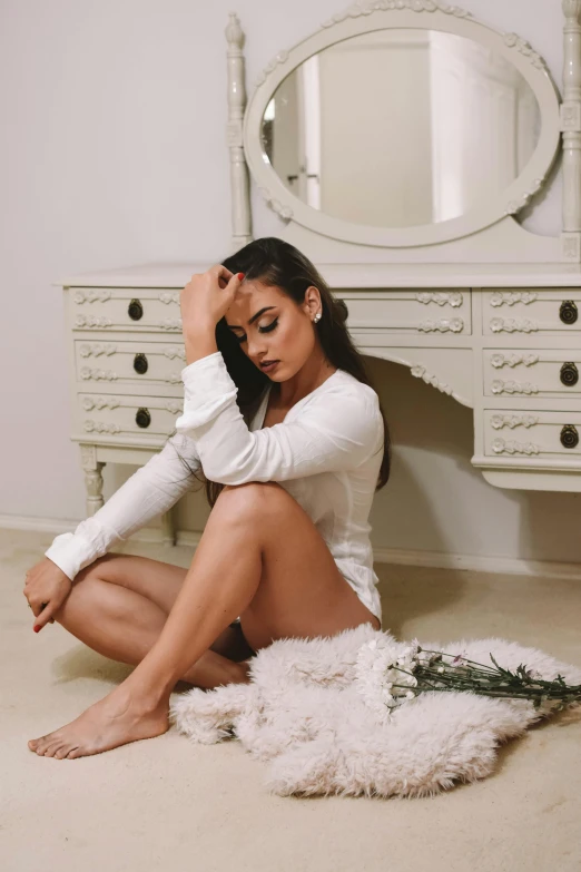 a woman sitting on the floor in front of a mirror, an album cover, by Robbie Trevino, instagram, renaissance, wearing a wet white short dress, wearing a hoodie and flowers, vanessa morgan, profile image