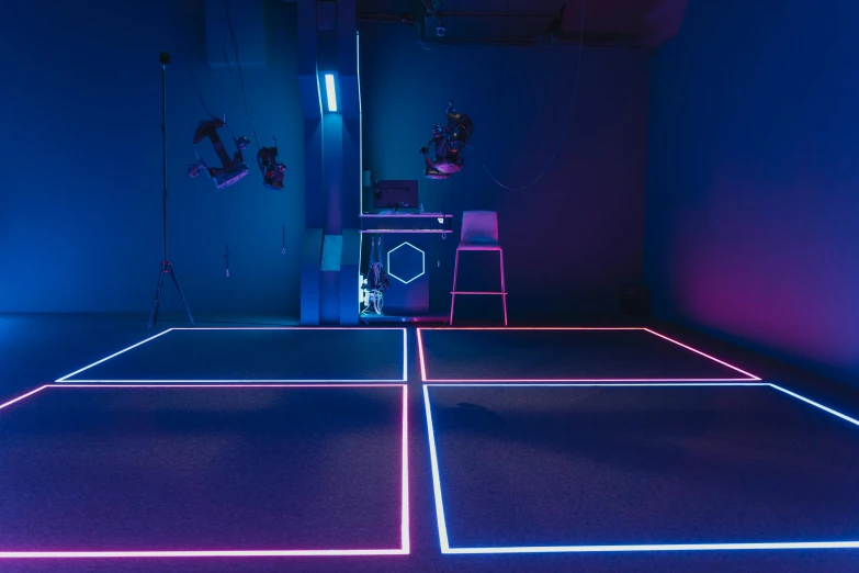 a room that has neon lights on the floor, a hologram, inspired by Beeple, unsplash contest winner, interactive art, an aerial tennis court, boston dynamics, dingy gym, sigma 55”