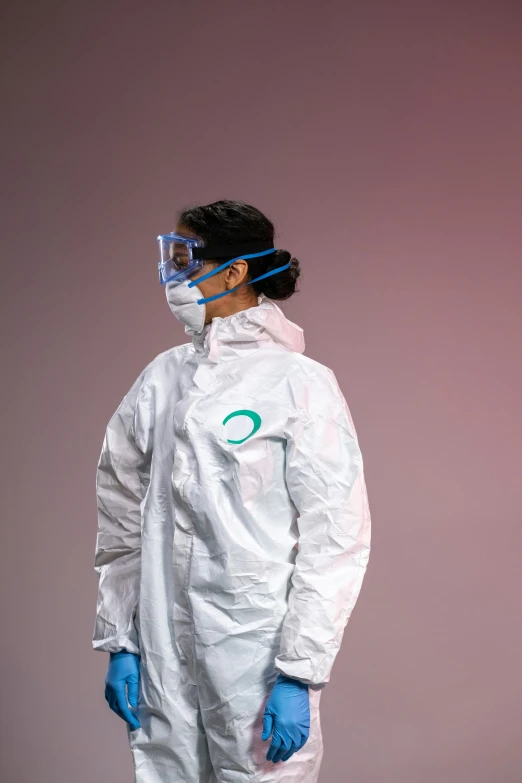 a man wearing a protective suit and goggles, by Ryan Pancoast, plasticien, white and teal garment, enso, photo from a promo shoot, photo of a woman