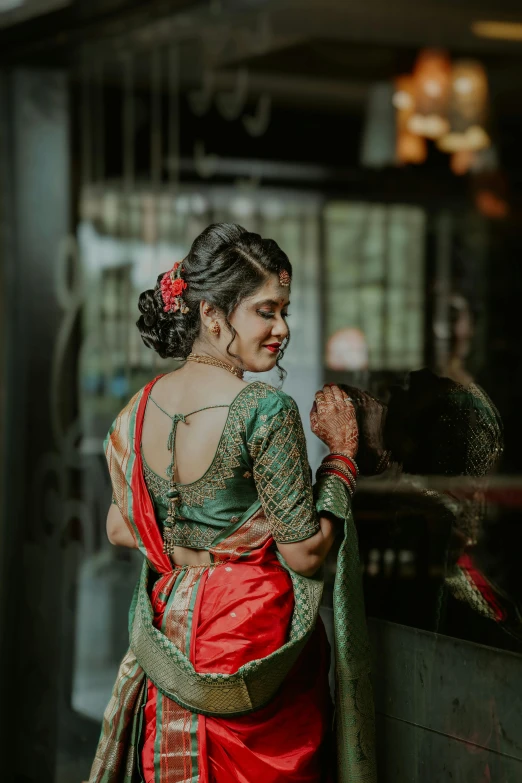 a woman in a red and green sari, pexels contest winner, showing her shoulder from back, trending on artstion, wedding, a cute young woman