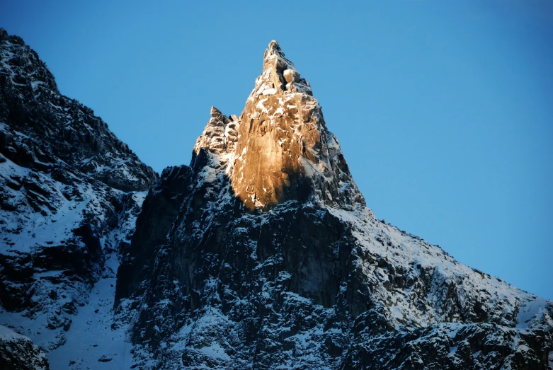 the top of a mountain covered in snow, pexels contest winner, hurufiyya, cone shaped, front lit, craggy, chamonix