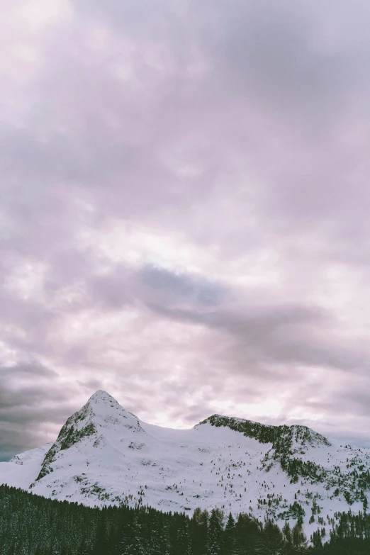 a couple of people riding skis on top of a snow covered slope, by Daniel Seghers, trending on unsplash, minimalism, soft lilac skies, in the swiss alps, 4 k cinematic panoramic view, giant clouds