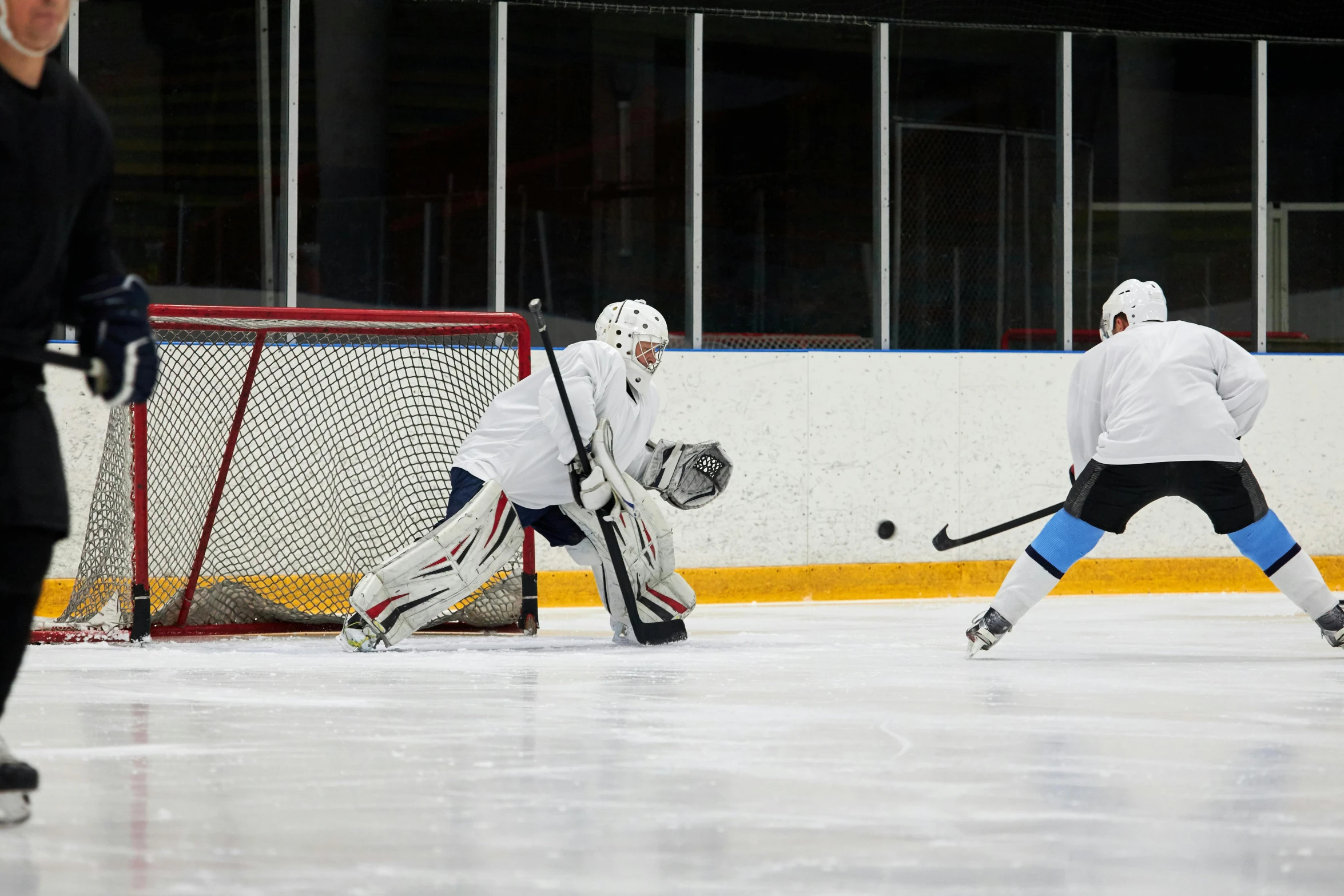 a group of men playing a game of hockey, full ice hockey goalie gear, 15081959 21121991 01012000 4k, no cropping, practice