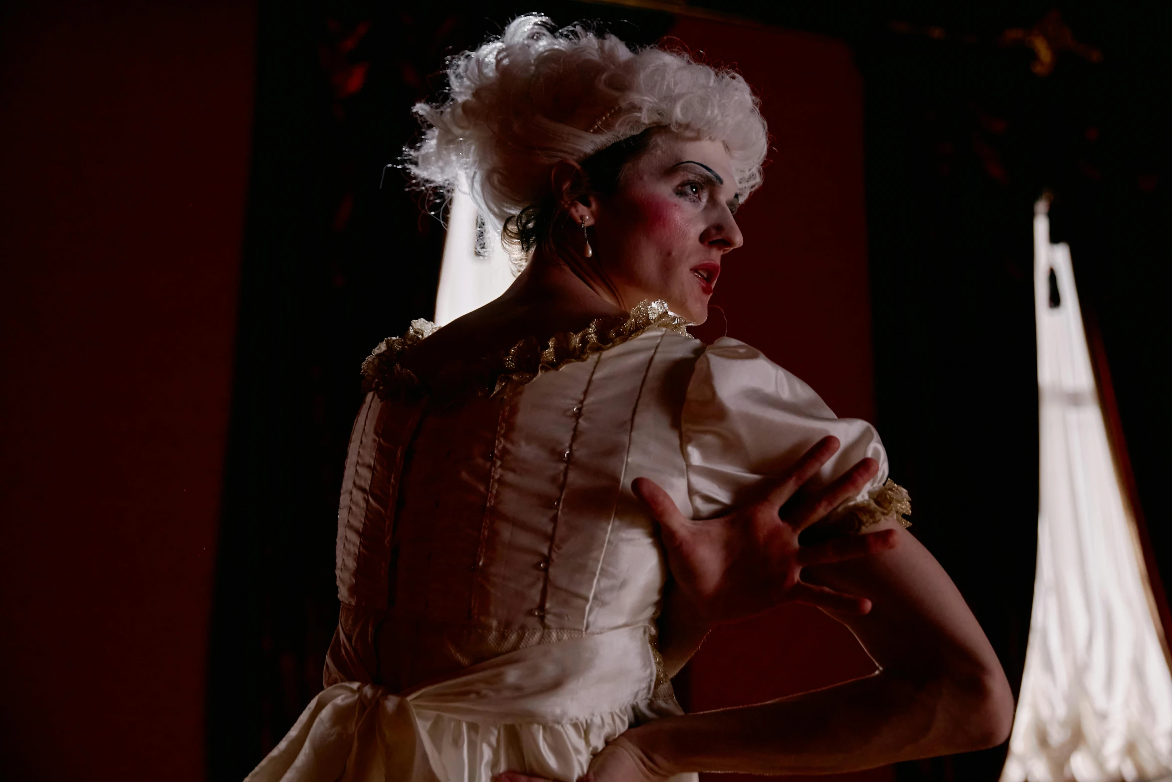 a woman in a white dress posing for a picture, inspired by Karl Bryullov, rococo, filmstill, drag, standing in a dimly lit room, performance