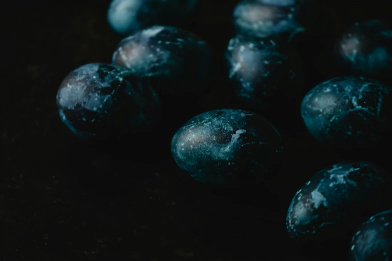 a bunch of blueberries sitting on top of a table, a macro photograph, inspired by Elsa Bleda, unsplash, bauhaus, dragon eggs, dark oil paint, background image