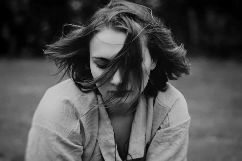 a black and white photo of a woman with her hair blowing in the wind, messy bob, 15081959 21121991 01012000 4k, girl with brown hair, shy looking down