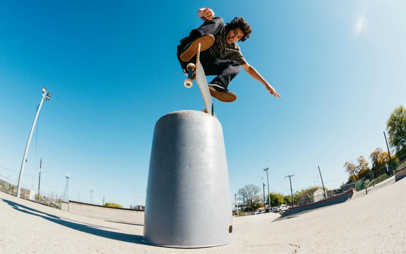 a man flying through the air while riding a skateboard, by Gavin Nolan, unsplash, photorealism, on a pedestal, cone, vsco film grain, macguire is a tall