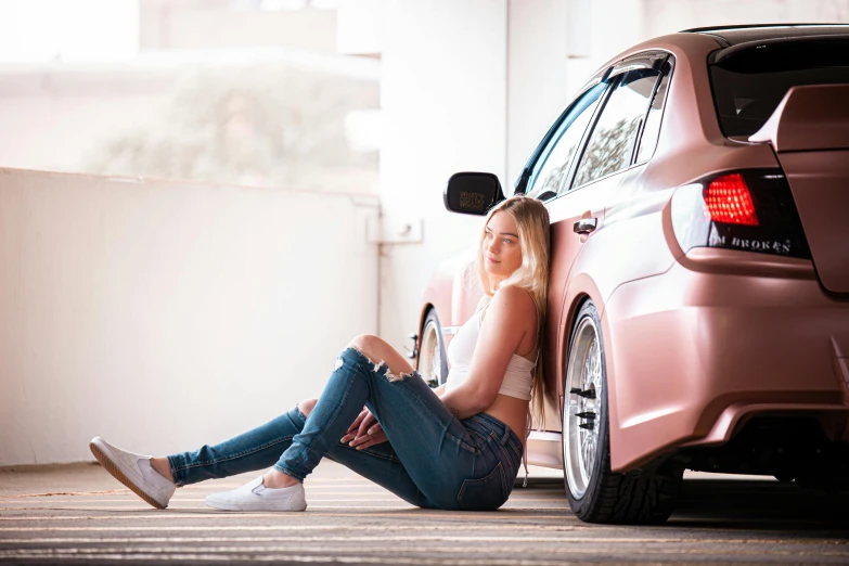 a woman sitting on the ground next to a car, inspired by Sydney Carline, pexels contest winner, brushed rose gold car paint, profile image, blonde, teenage girl