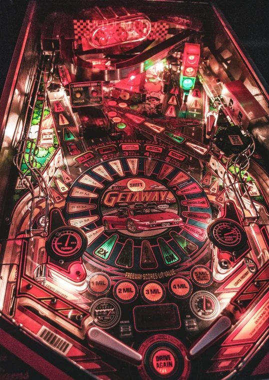 a pinball machine sitting on top of a table, lit from above, red and cinematic lighting, top down view, instagram post