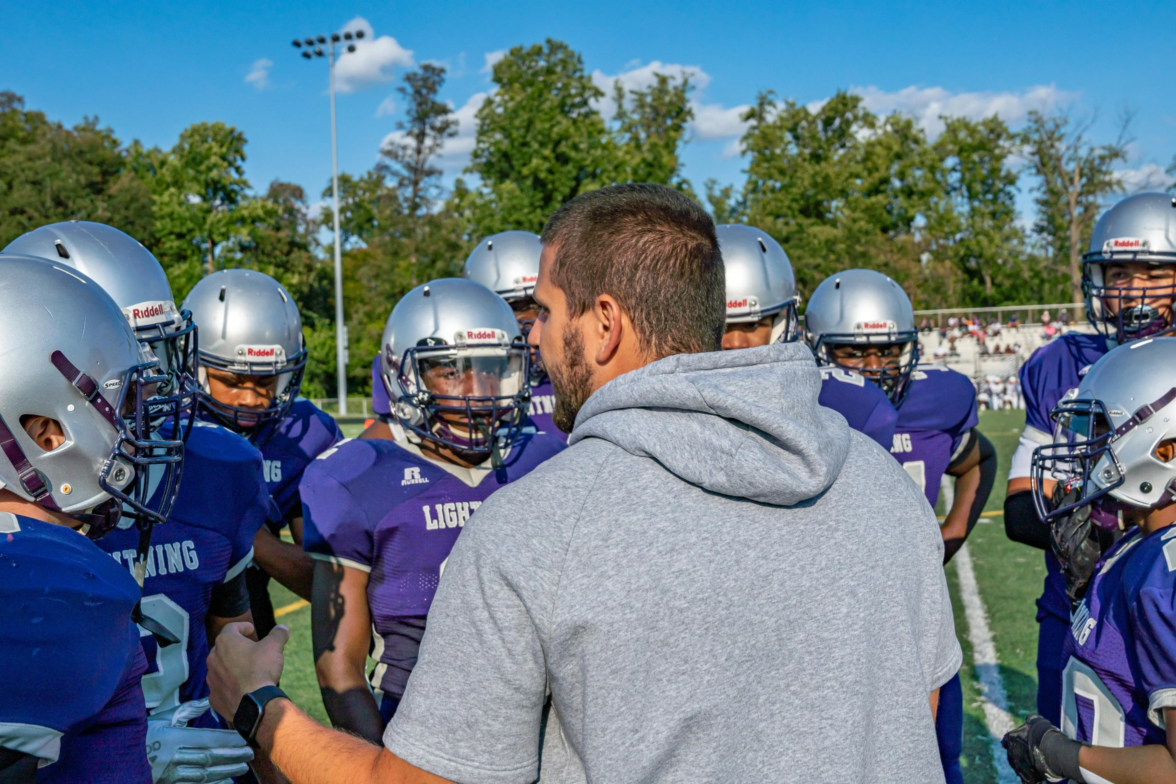 a group of football players standing on top of a field, lucas graziano, teaching, 15081959 21121991 01012000 4k, a purple and white dress uniform