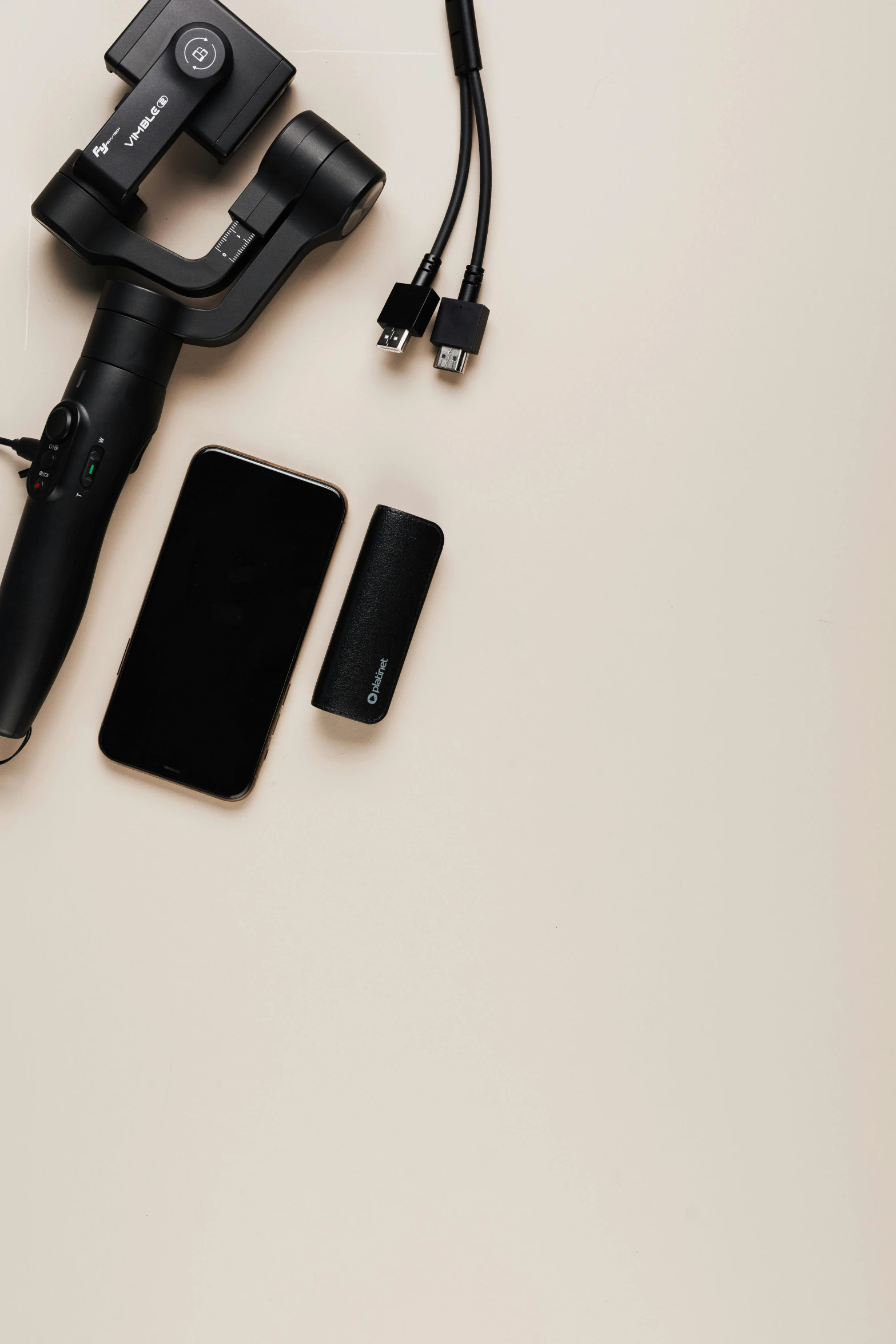 a cell phone sitting on top of a table next to a camera, by Matthias Stom, trending on pexels, minimalism, with electric arc device, high angle close up shot, battery, on hasselblaad