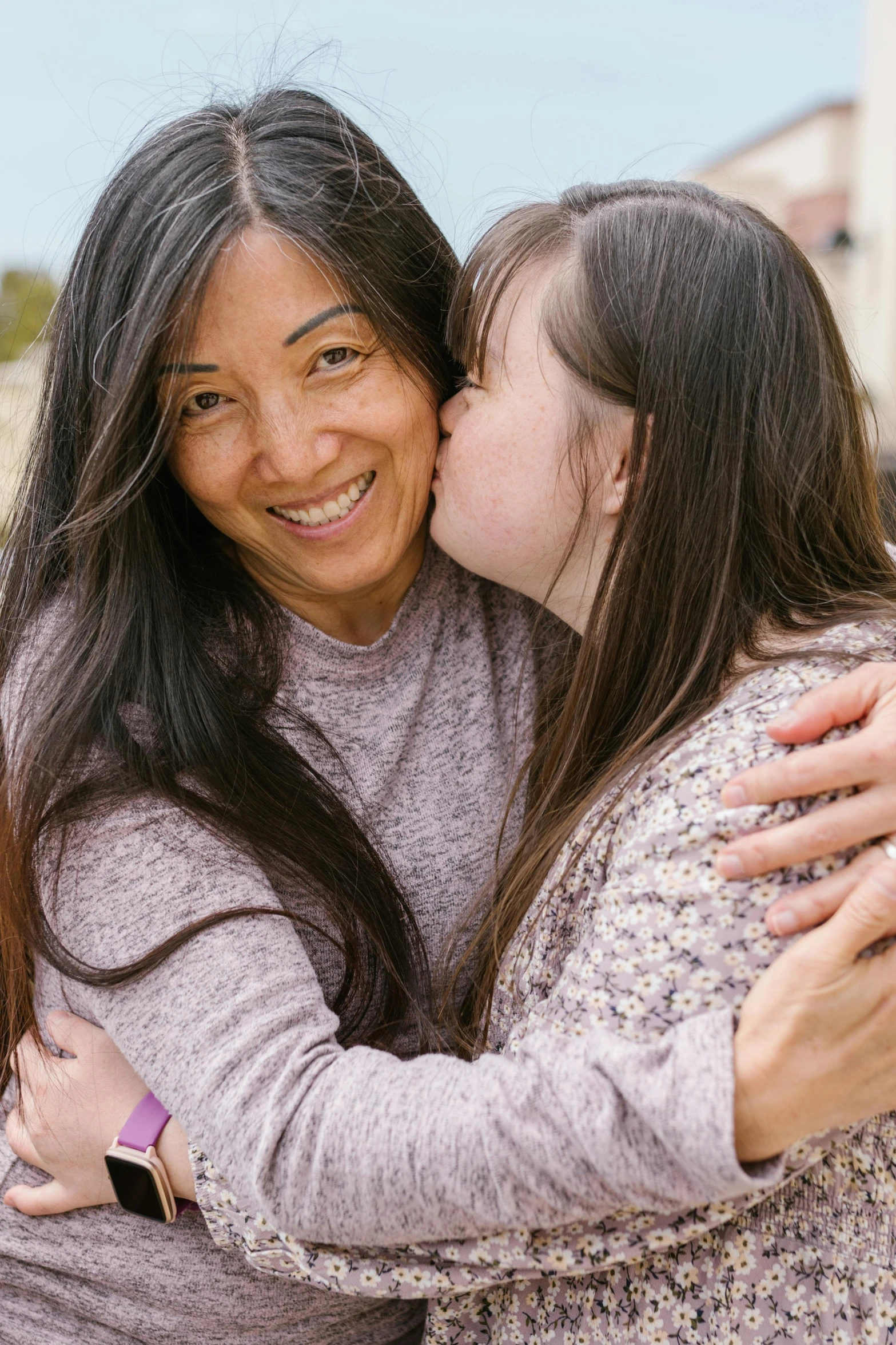 a woman giving a girl a kiss on the cheek, female with long black hair, compassion, joy ang, lgbtq