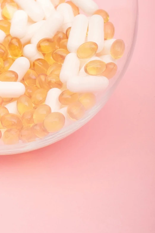 a glass bowl filled with yellow and white pills, trending on pexels, photorealism, salmon, beads of sweat, vanilla, medical labels