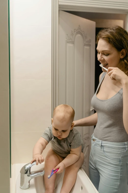 a woman brushing a baby's teeth in a bathroom, pexels contest winner, renaissance, square, good looking, grey, small