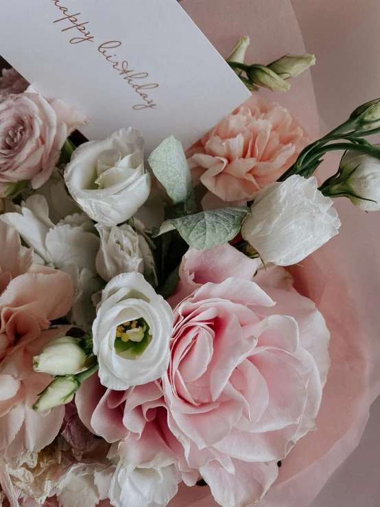 a close up of a bouquet of flowers on a table, light pink mist, white and pink, carefully crafted, cheery