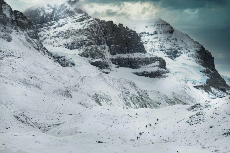 a group of people walking up a snow covered mountain, inspired by Michal Karcz, pexels contest winner, surrealism, icy glaciers, banff national park, movie still from game of thrones, panoramic photography