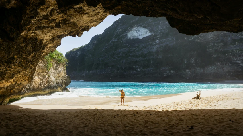 a person standing in a cave on a beach, bali, avatar image