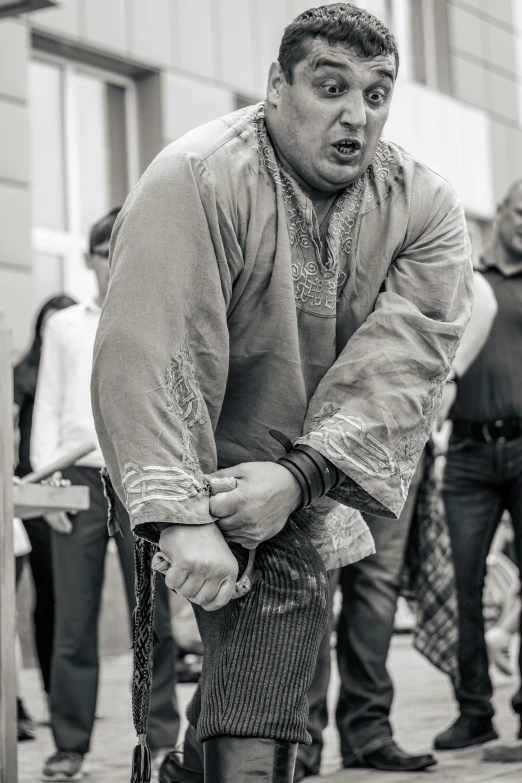 a black and white photo of a man with a cane, by Jan Tengnagel, unsplash, renaissance, sumo wrestler, tied - up shirt, performance, annoyed