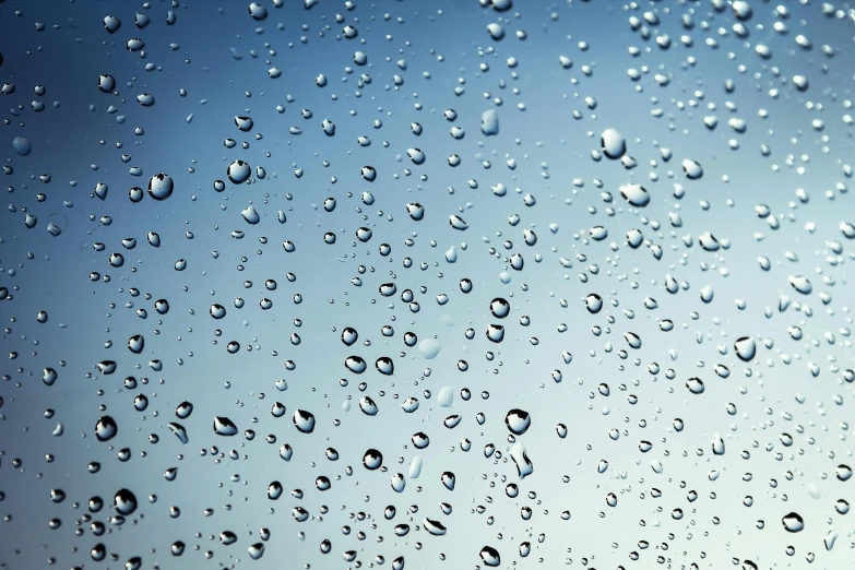 a close up of water droplets on a window, an album cover, unsplash, shades of blue and grey, hydration, dry skin, seen from below