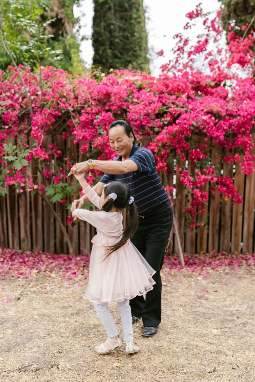 a man teaching a little girl how to fly a kite, an album cover, inspired by Cui Bai, pexels contest winner, arabesque, prima ballerina in rose garden, bougainvillea, jung gi kim, profile image