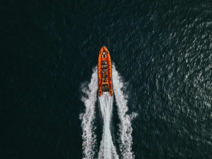 a boat in the middle of a body of water, pexels contest winner, orange and white, hyperspeed, photograph from above, dark. no text