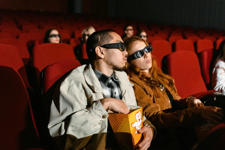 a group of people sitting in a theater wearing blindfolds, a cartoon, trending on pexels, hyperrealism, wearing orange sunglasses, couple, russian cinema, instagram post