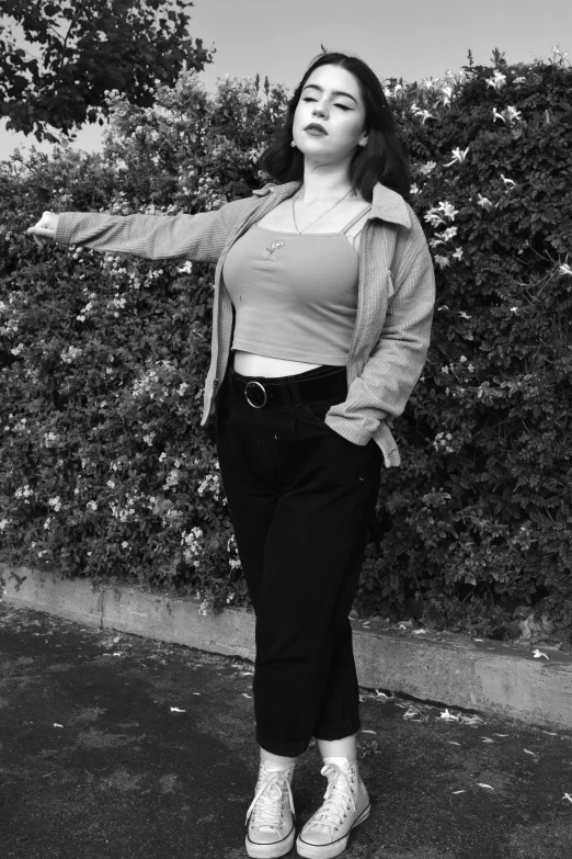 a black and white photo of a woman throwing a frisbee, inspired by Ion Andreescu, realism, cropped shirt with jacket, ✨🕌🌙, as if lisa simpson came to life, pose 4 of 1 6