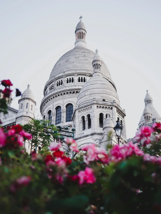 a close up of a building with flowers in front of it, domes, saint womans, instagram picture, background image