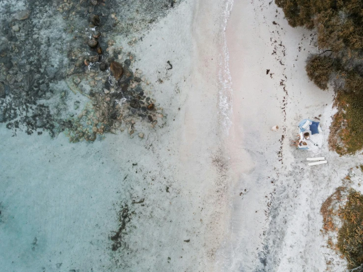 an aerial view of a beach with a boat in the water, a screenshot, unsplash contest winner, ground level shot, aussie, bahamas, grey