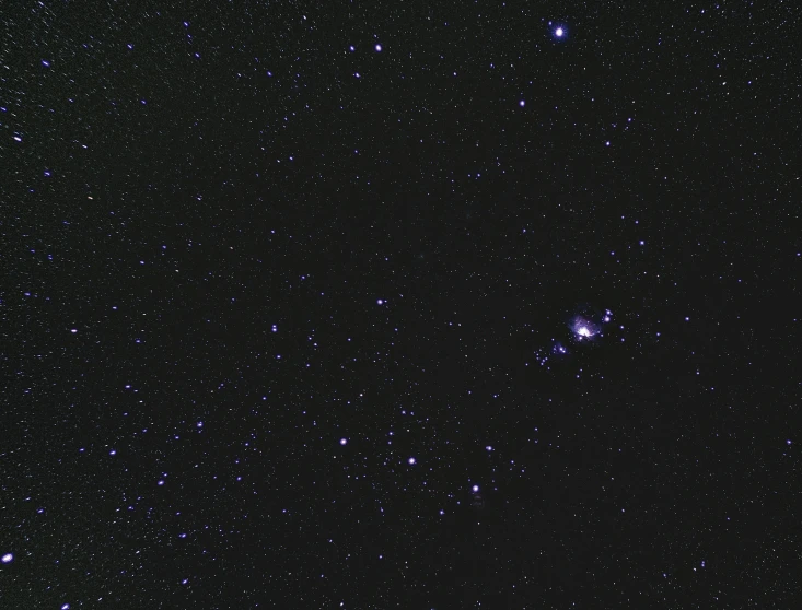 a dark sky filled with lots of stars, grainy low quality photograph, pulsar, looking towards the camera, high-quality dslr photo”