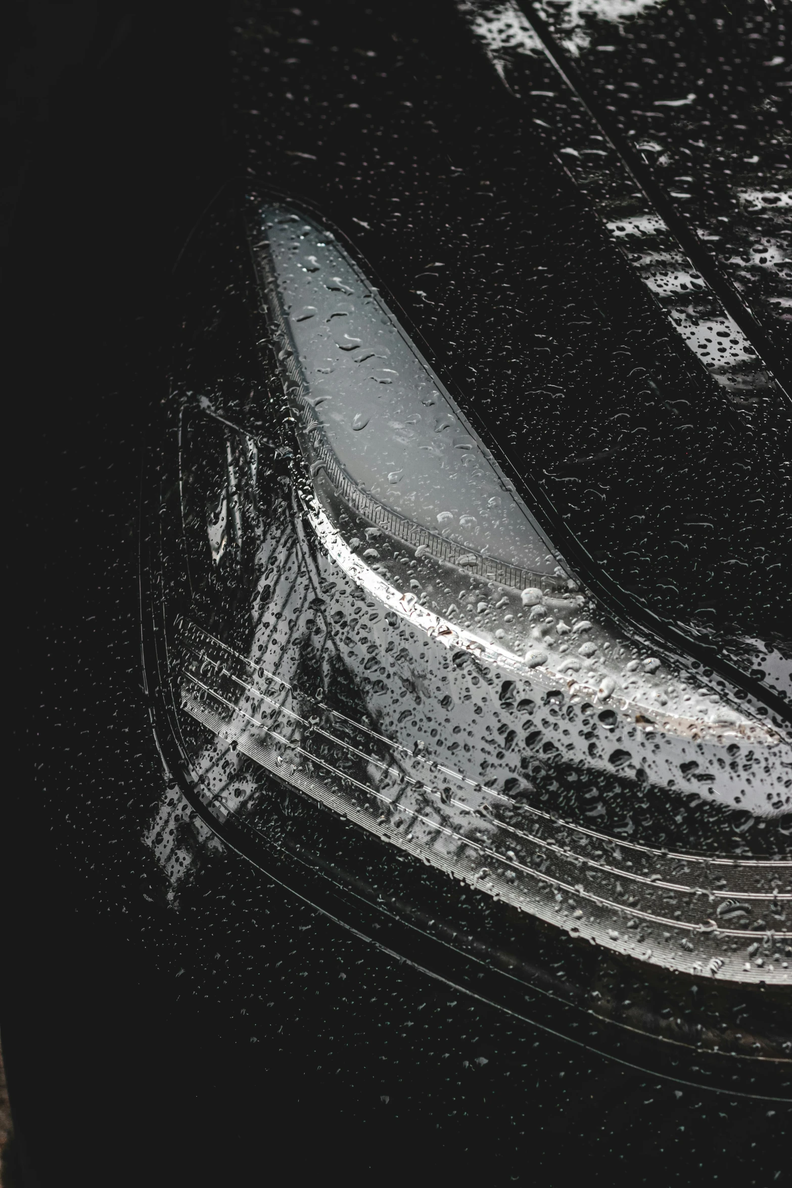 a close up of a banana on a wet surface, pexels contest winner, black car, 2 0 % pearlescent detailing, grey mist, gleaming silver