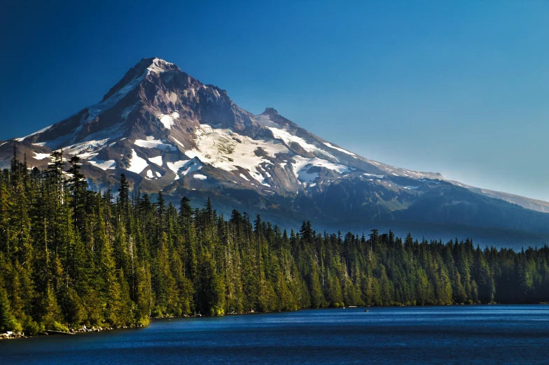 a mountain that is in the middle of a lake, a photo, cascadia, fan favorite, snow capped mountains, istock