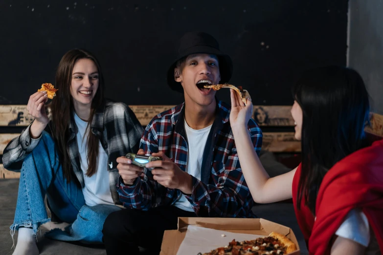 a group of people sitting on a couch eating pizza, a portrait, pexels contest winner, wearing jeans and a black hoodie, lachlan bailey, profile image, serving suggestion