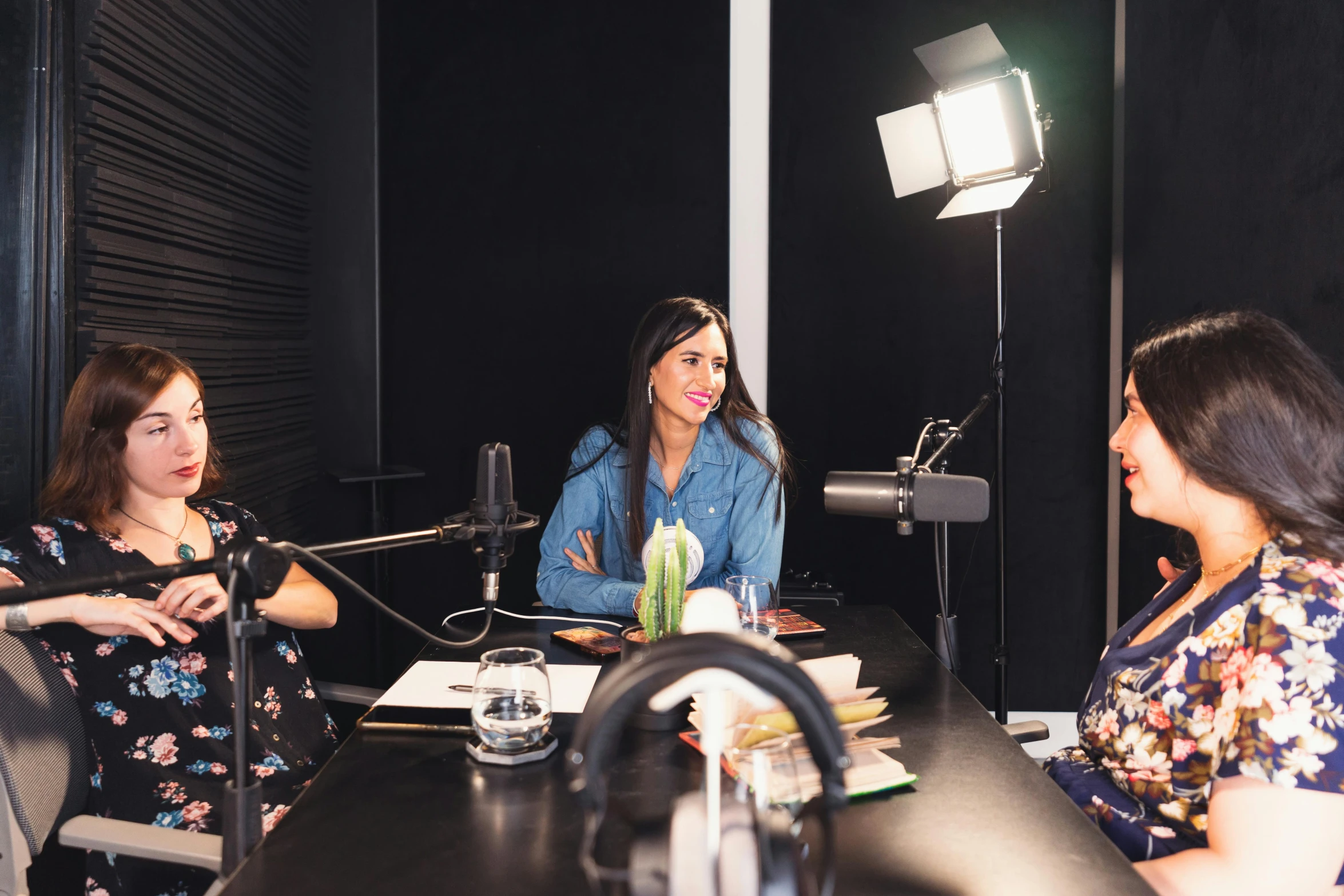 a group of women sitting around a table, sitting in front of a microphone, profile image, mia khalifa, professional studio